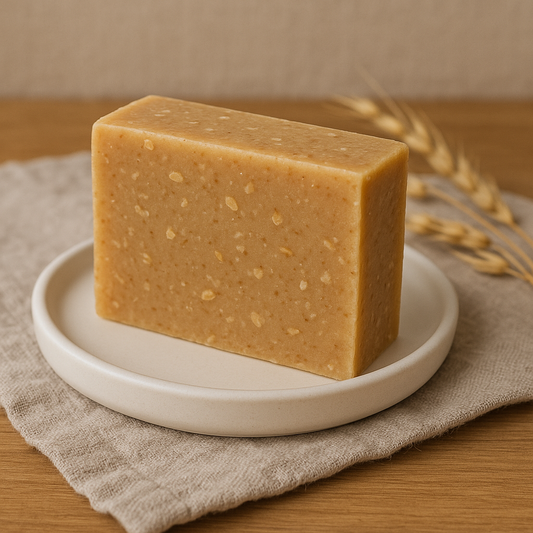Bar of oatmilk & honey soap on a white plate with a neutral background